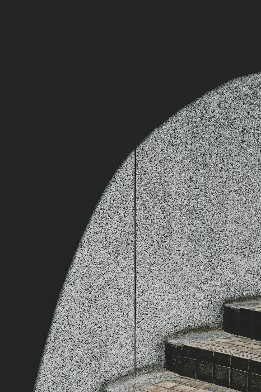 a black and white photo of a person walking up some stairs