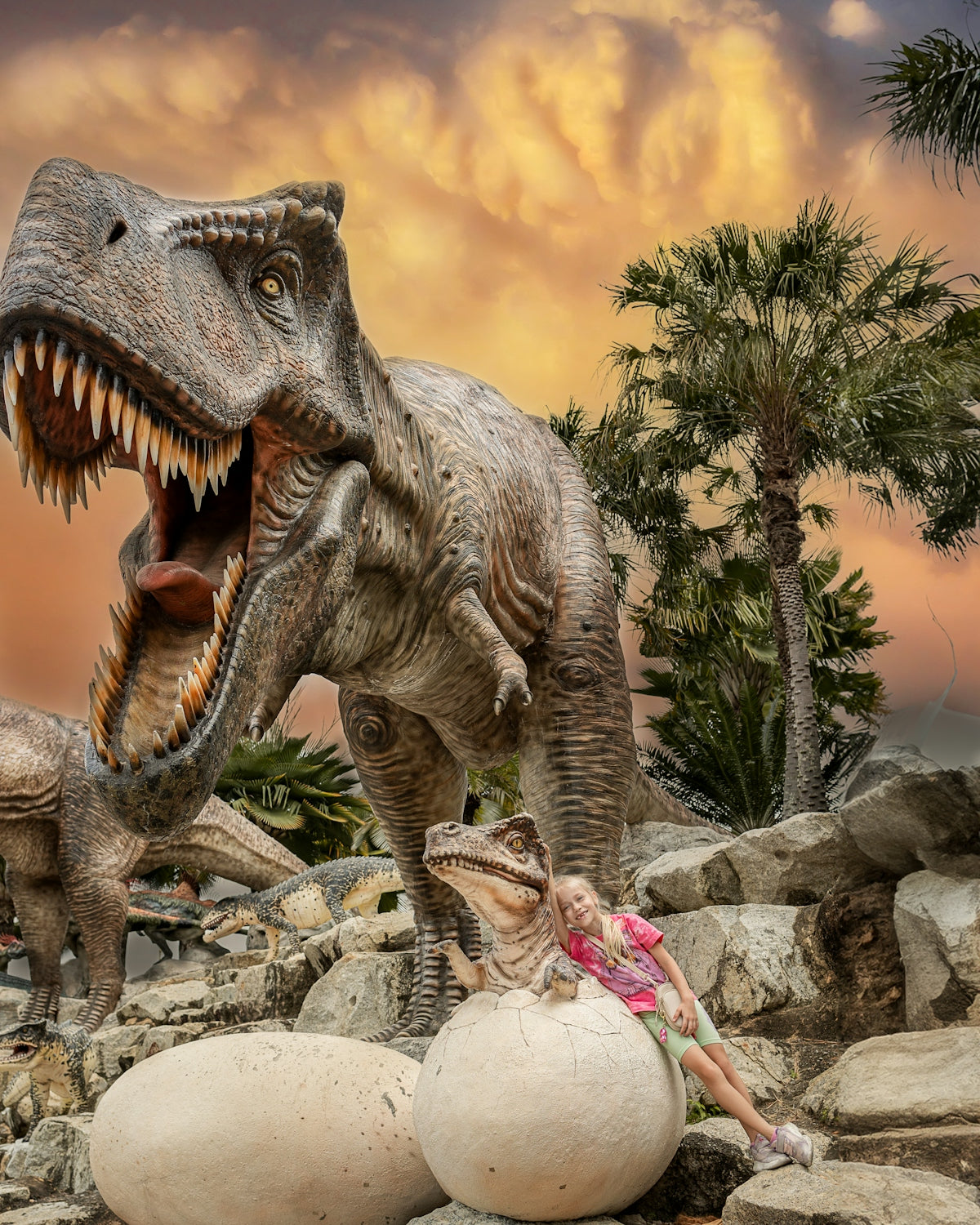 a woman laying on a rock next to a fake dinosaur